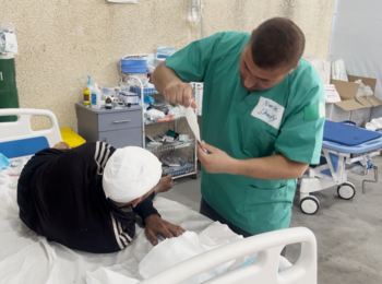 A nurse treating an injured person in a newly established trauma stabilization point in Rafah. Photo by OCHA, 19 May 2024 