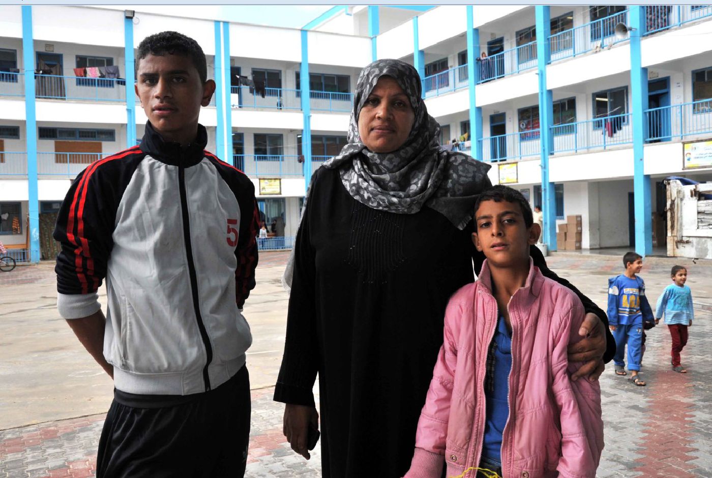 Afaf and two of her nine children at the UNRWA Collective Centre. Photo by UNRWA