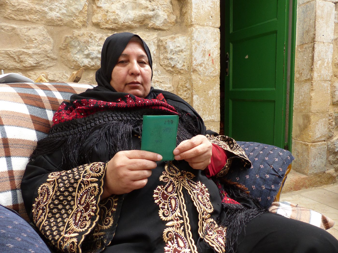 Jamila Ash Shaladih with her numbered ID, without which she is not allowed to stay in her neighbourhood