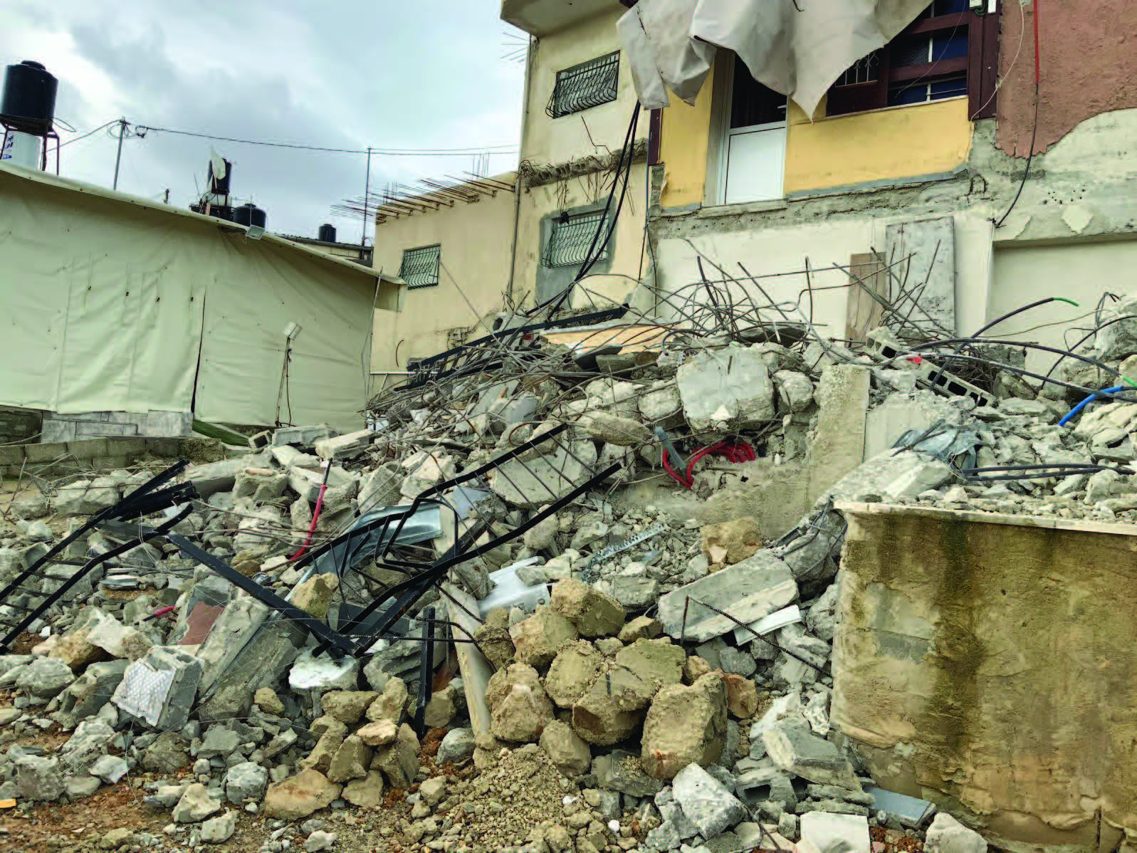 A Palestinian family forced to demolish their home in Jabal al Mukabbir, East Jerusalem. ©Photo by OCHA, 1 February 2023