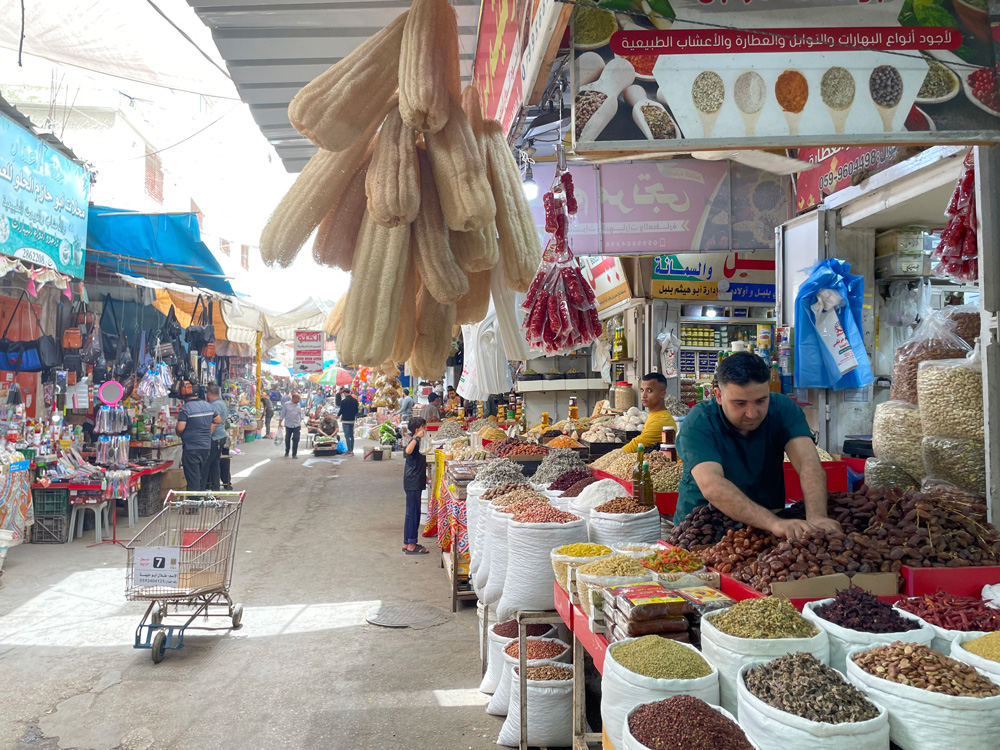 An active marketplace in Gaza City where most of the consumable commodities seem available, yet limited purchasing power persist