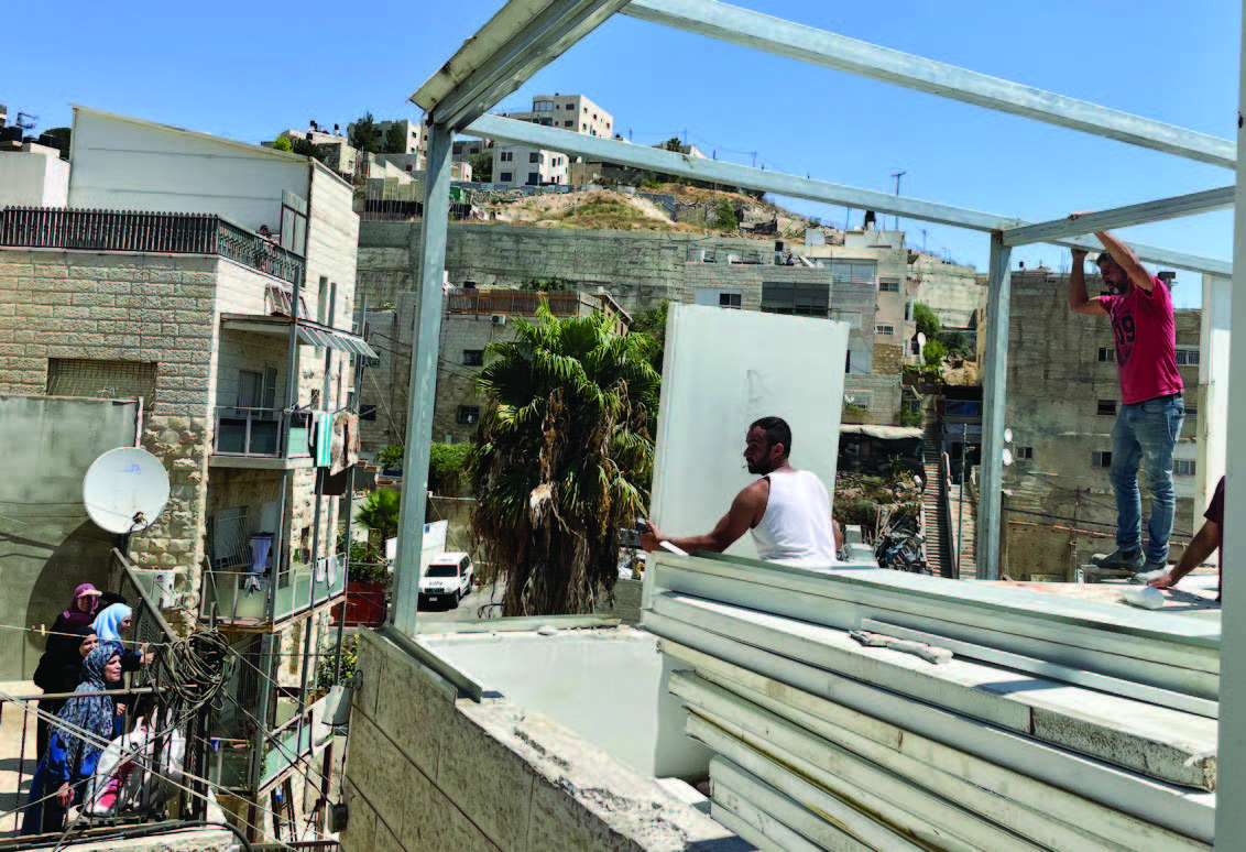 A Palestinian family forced to demolish their home in Ras Al ‘Amud, East Jerusalem. Photo by OCHA, 24 August 2022.