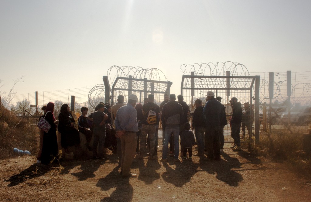 Farmers waiting to access their olive groves behind the Barrier, next to Beit Surik village (Ramallah), 31 October, 2019. ©  Photo by OCHA