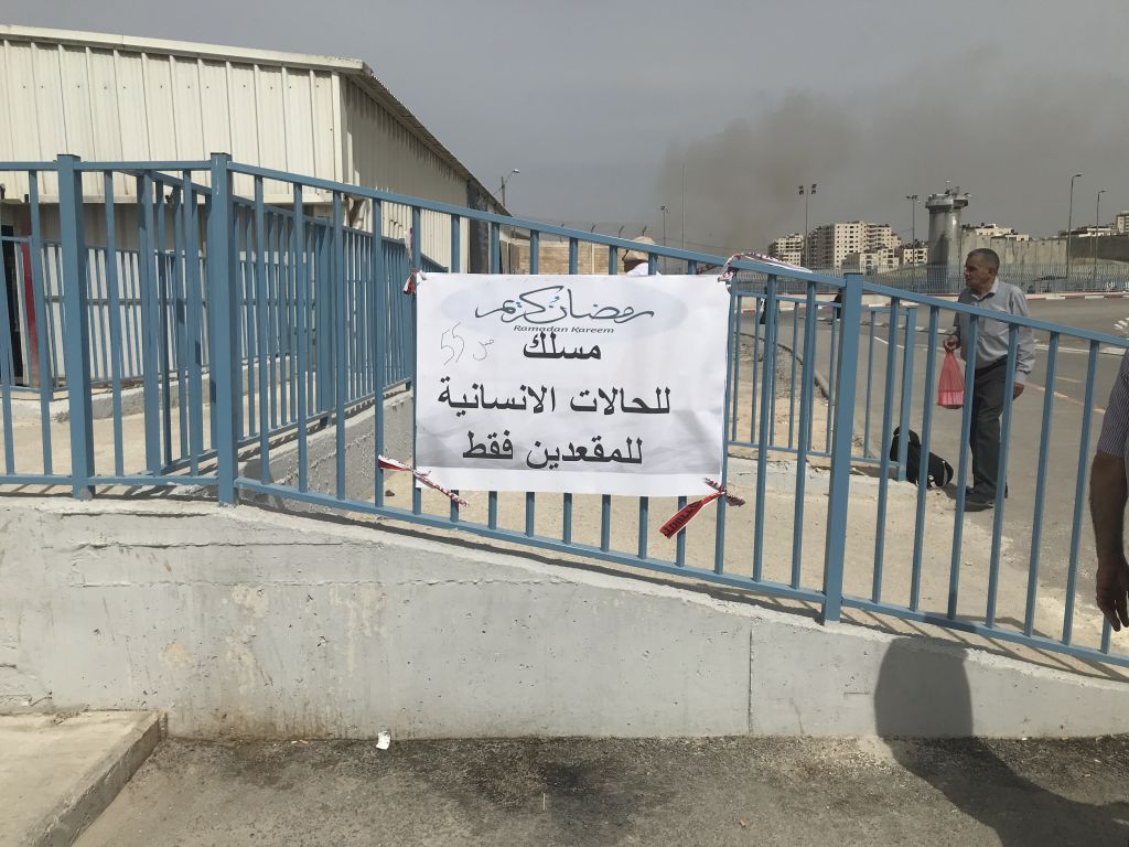 Sign for humanitarian lane: “humanitarian lane only for wheelchair users” Qalandiya checkpoint Friday 24 May. © Photo by OCHA