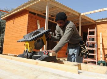 Cutting Beams. Photo by Shareef Sarhan for CRS