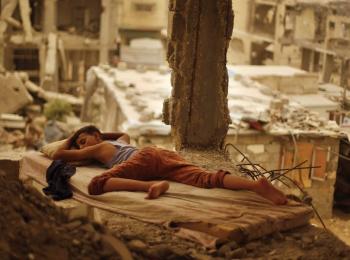 Palestinian boy sleeping inside his destroyed home in the Shuja’iyeh neighbourhood of Gaza City, September 2015. Photo by Suhaib Salem