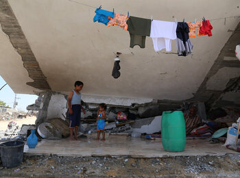 Family residing in a severely damaged home in Johr ad Deek