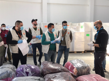 Staff of an aid organization preparing for the distribution of bedding sets to isolation centers. April 2020, Rafah. Photo by NRC