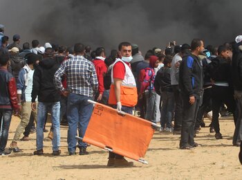 A member of the Palestine Red Crescent Society attends the Great March of Return demonstrations on 27 April 2018 to provide health support to those injured.