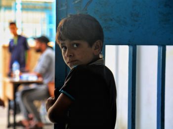 A Palestinian boy from a family seeking protection at an UNRWA school in Gaza during the May 2021 escalation of hostilities. © Photo by Mohammad Lubbad