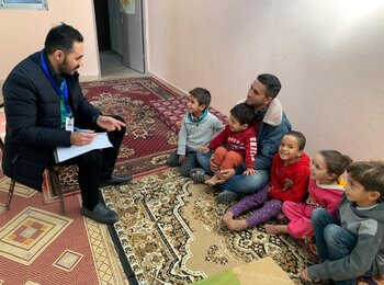 Ali and his five children (on the right) while being interviewed by a member of the project team.