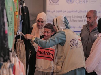 A child in Gaza getting new clothes with vouchers provided by the Beit Lahia Development Association (BLDA) and the International Migration Organization (IOM) through funding from the Central Emergency Response Fund (CERF). Photo by BLDA 