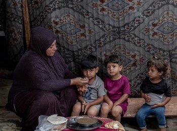 Laila, a mother from Gaza, has been displaced over 17 times. With no source of income, she cares for her children and relatives with chronic illnesses. "Without the community kitchen, I don't know what we would do," she says. Photo by WFP