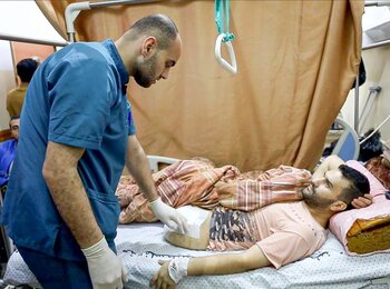 A medical team member attending the wounds of a Palestinian in Gaza. Photo by the World Health Organization 