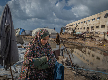 Najat stands outside of her tent in Gaza city, which was flooded after a sewage system nearby overflooded due to heavy rain. Photo by WFP/Maxime Le Lijour 