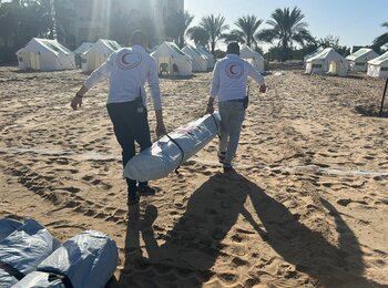 Teams preparing for the establishment a field hospital in Rafah, southern Gaza. The Qatari field hospital is set to have a capacity of 50 beds, an operating room, intensive care unit, reception, and radiology services. Separately, with facilities for displaced people being overcrowded, thousands of people have relocated to this site. Photo: Palestine Red Crescent Society