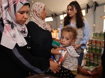 A Palestinian child being screened for malnutrition in Khan Younis, as new supplies arrived following almost 80 days of full blockade on any cargo entering the Gaza Strip. Photo by UNICEF, 25 May 2025 