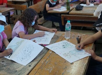 Girls participating in the drawing corner. 5 July 2021. Photo by OCHA.