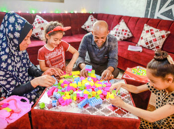 Asma and Sade playing with two of their daughters in their renovated livingroom. Asma and Sade playing with two of their daughters in their renovated livingroom.