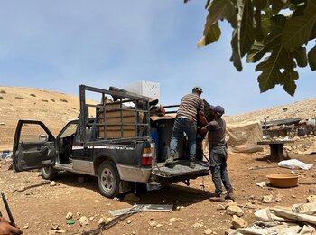 Residents of the Palestinian herding community of Ein al Hilwa – Wadi al Faw dismantling their homes and other structures following recurrent attacks and intimidation by Israeli settlers, which restricted their access to water sources and grazing areas. Photo by OCHA