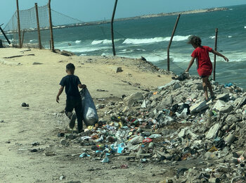 Children scavenging on Gaza’s shore. Photo by OCHA/Olga Cherevko