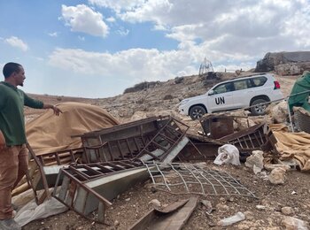 A resident of the Palestinian herding community of Khirbet Tell al Khashaba, in Nablus governorate, showing a UN team what remains of structures that Israeli authorities demolished. Photo by OCHA