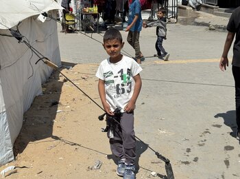 A Palestinian boy in a site for displaced people in Gaza city. Photo by OCHA/Olga Cherevko    