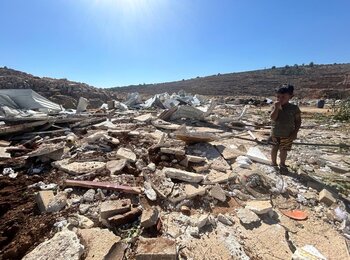 A child stands among the rubble after Israeli authorities demolished his family's home and other residential and donor-funded structures in a Bedouin community in Qalqiliya governorate on 14 July 2026. Photo: OCHA 