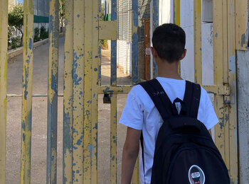 The son of Saadat Gharib standing in front of a gate installed by the Israeli military. The gate controls access to his family’s home, now encircled by settlement infrastructure. Photo by Shafea Jalamneh / Médecins du Monde Spain, Beit Ijza, East Jerusalem.