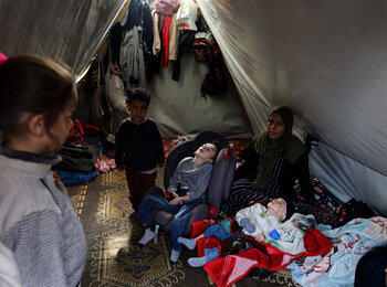 “None of the children has winter clothes. Four of us are sharing a single mattress… The little one sleeps in his carrier... They are all with diarrhea… It’s cold… Hatem has a cough. Their skin is peeling…” Mena, a single mother staying with her four children, including two with disabilities, in a makeshift tent in Al Quds Open University, Gaza. Photo by UNICEF/El Baba, 11 January 2024