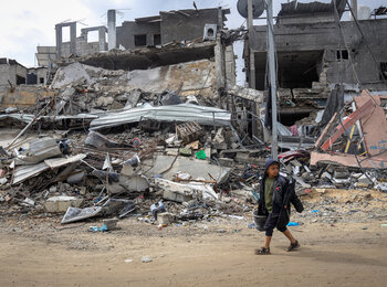 Nine-year-old Tamer walks through the rubble of his destroyed neighbourhood in Khan Younis. Photo by UNICEF/Eyad El Baba 