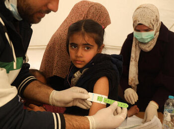 A girl undergoing Mid-Upper Arm Circumference (MUAC) screening at a UNICEF-supported pediatrician clinic in Rafah. Photo by UNICEF/El Baba 