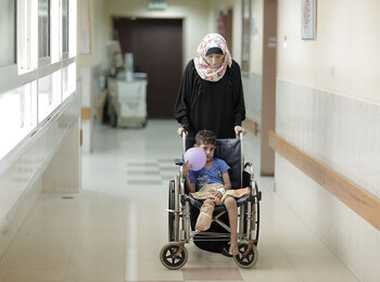 A mother and son in the orthopedic department at Ash Shifa hospital, Gaza City, October 2015