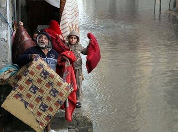 Family evacuating their home in Gaza, 12 December 2013