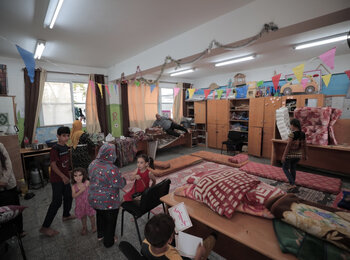 Displaced people staying in a school. Photo by UNRWA/Mohammad Hinnawi