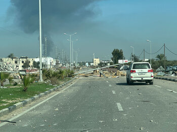 Damaged roads and intense hostilities are among the challenges faced by humanitarian workers struggling to support people in need across Gaza. A United Nations car driving on a damaged road in Deir al Balah. Photo by OCHA/Olga Cherevko, 18 January 2024 