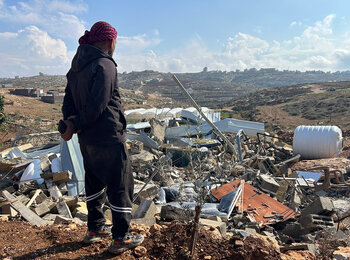Tha’er Harb looking over what is left of his property after Israeli authorities demolished his home and five other structures in Khallet Al Farra area of As Samu’ for lacking Israeli-issued building permits in Area C of the southern West Bank. Photo by OCHA, 10 December 2025.