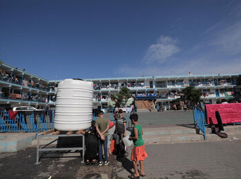 Displaced children queueing for water in a UN shelter in Gaza. Photo by UNRWA 