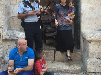 Settler family leaving Palestinian evicted property in East Jerualsem, shortly after taking it over on 15 September 2016. Photo by OCHA