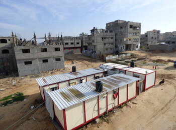 Caravans provided to displaced families and buildings under reconstruction in Shuja’iyeh neighbourhood, Gaza city, January 2016. © Photo by OCHA