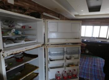 Sabreen shows her empty fridge. 3 December 2020, Gaza City. Photo by GPC