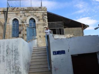Mr. Salah in front of his family home from which he was evicted. Photo by OCHA