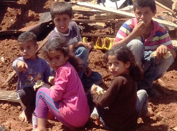 Palestinian refugee children from East Tayba Bedouin community, following the demolition of their home, 20 August 2014. Photo by OCHA