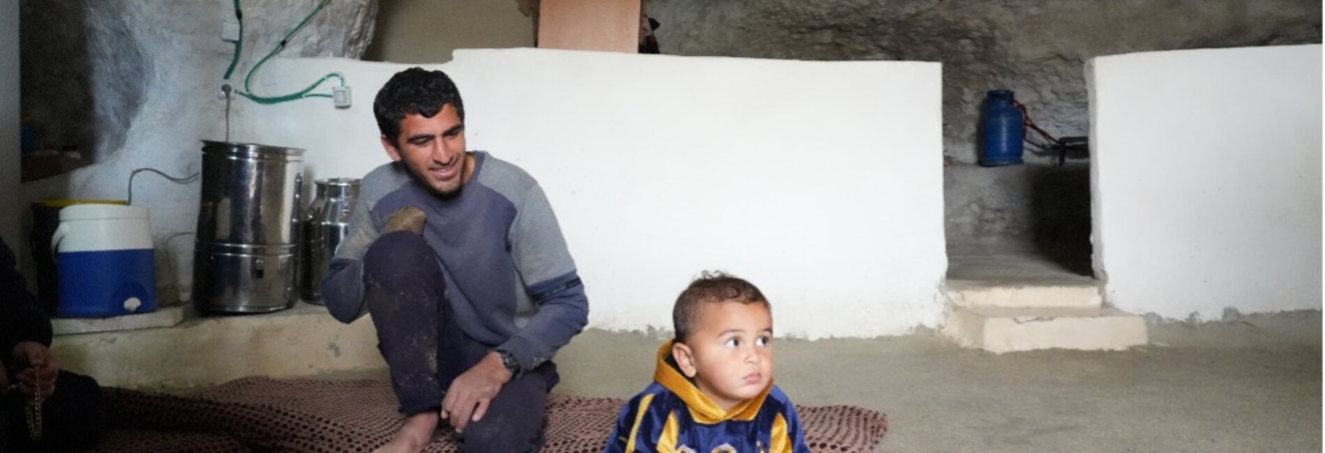 Mohammed and his baby at home. Photo: Ma'an
