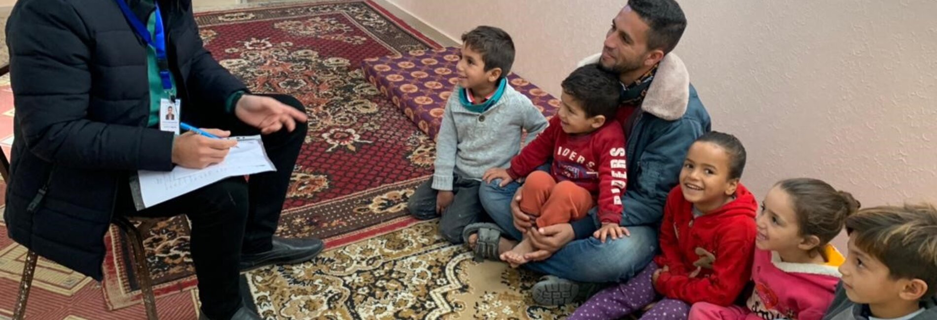 Ali and his five children (on the right) while being interviewed by a member of the project team.