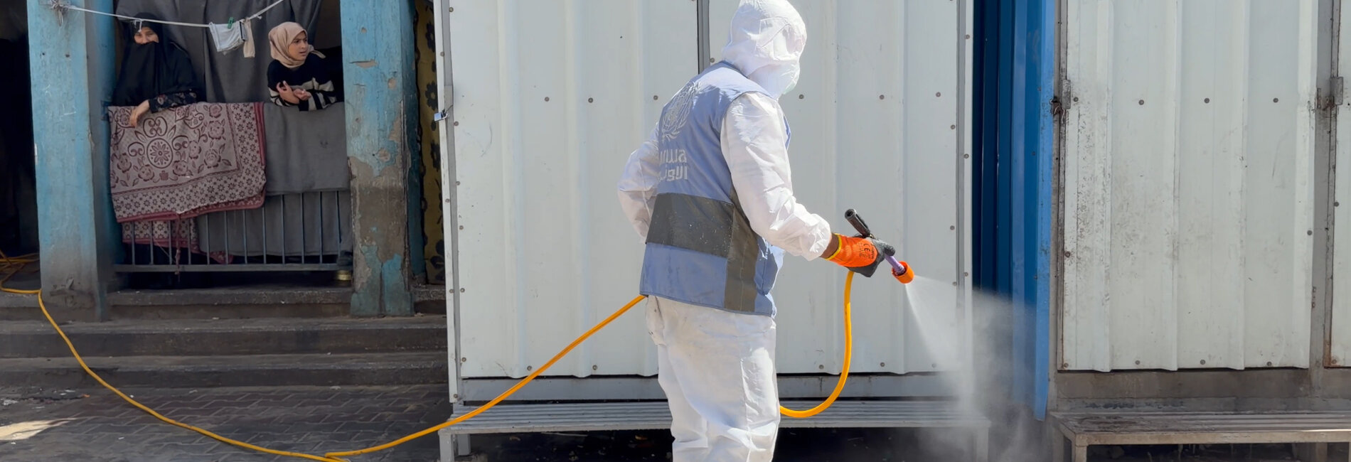 Spraying pesticides at an UNRWA school used as a shelter for displaced people in Gaza, May 2026. Photo by OCHA