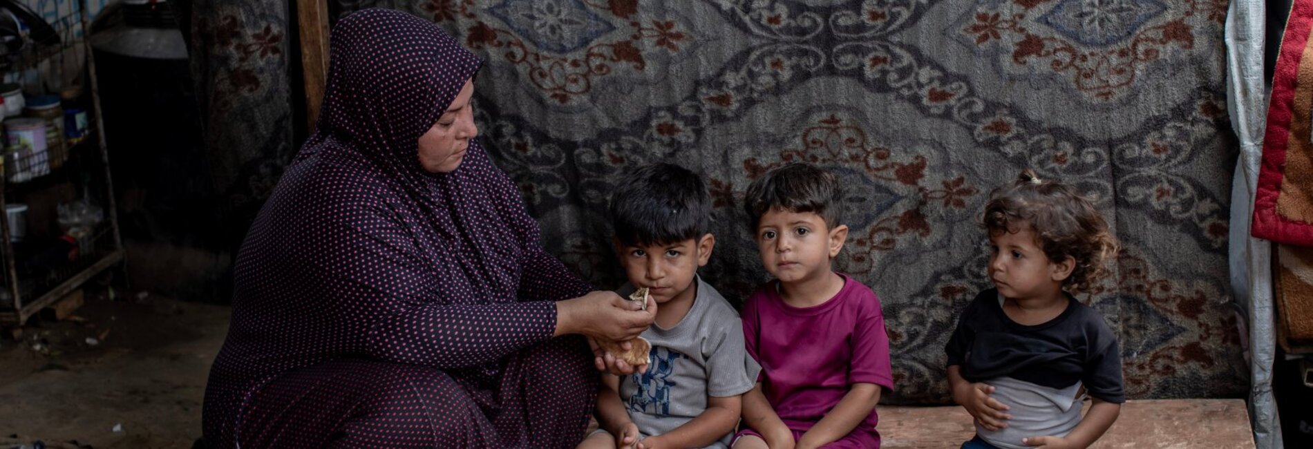 Laila, a mother from Gaza, has been displaced over 17 times. With no source of income, she cares for her children and relatives with chronic illnesses. "Without the community kitchen, I don't know what we would do," she says. Photo by WFP
