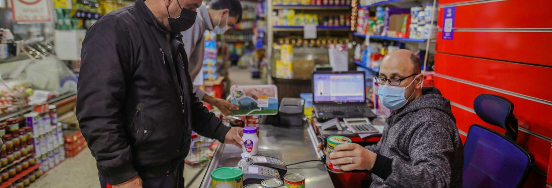 Using an e-voucher, Mohammed selects food and living supplies for his family. Photo by Mohamed Reefi for CRS