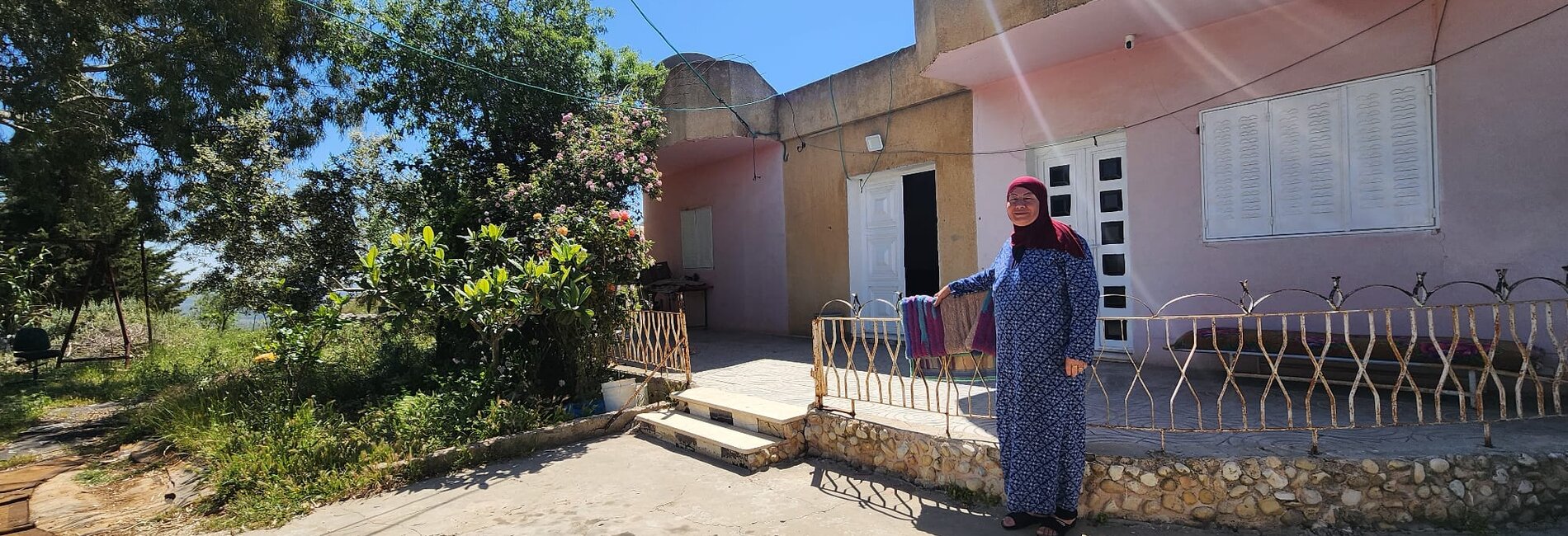 Umm Saleh Shreteh standing in front of her house in Al Mazra’a Al Qibliya, the central West Bank. Photo by OCHA