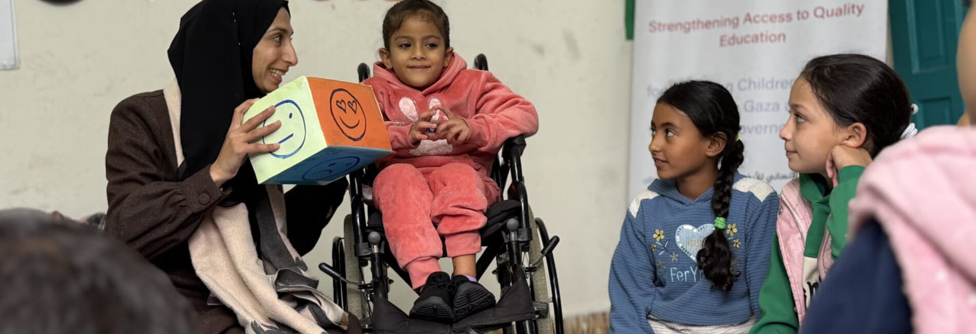 Six-year-old Dana (seated on a wheelchair) at the project centre where she receives education and psychosocial support. Photo by PSCF, 11 December 2025.